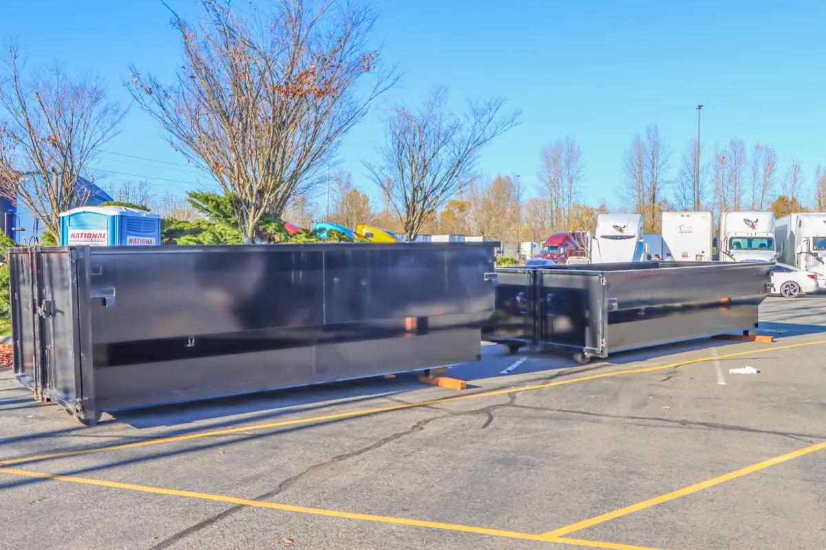 Professional dumpster rental service with roll-off container on residential driveway in Auburn Hills